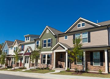 Several connected Townhouses with small trees out front